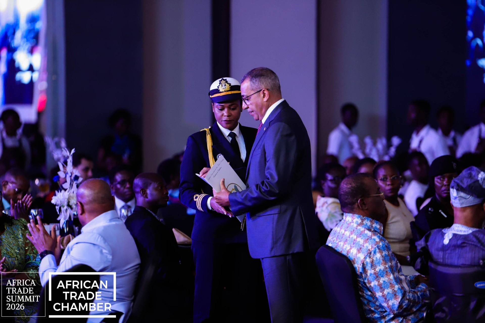 Officials completing a formal document exchange on the Africa Trade Awards stage